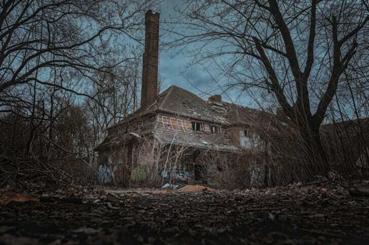 Brick House in the Middle of the Woods Under Cloudy Day Sky