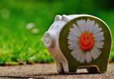 花をペイントされた豚の貯金箱の写真