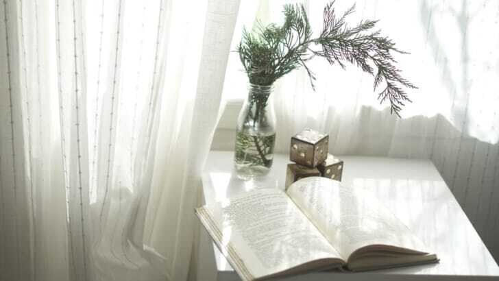 book opened on top of white wooden table