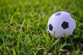 white and black soccer ball on green grass during daytime